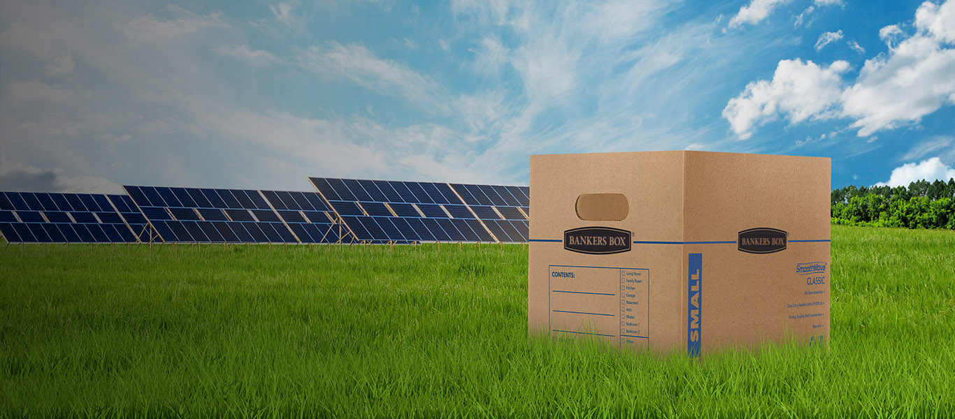image of a moving box on the ground with green grass and trees around it