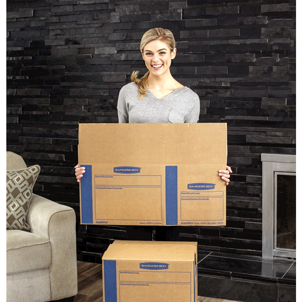 Woman carrying an unassembled box