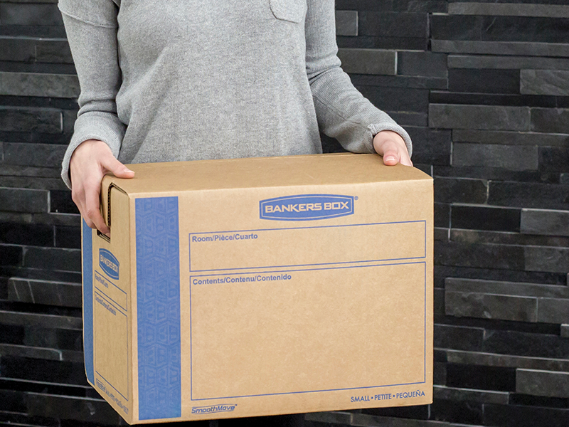 woman carrying moving boxes