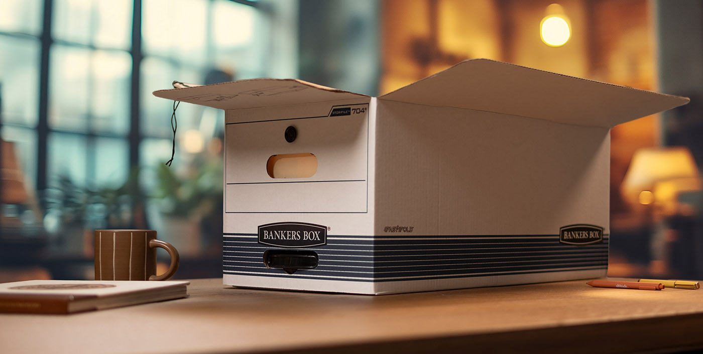 Photo of a man and woman in their kitchet packing a box