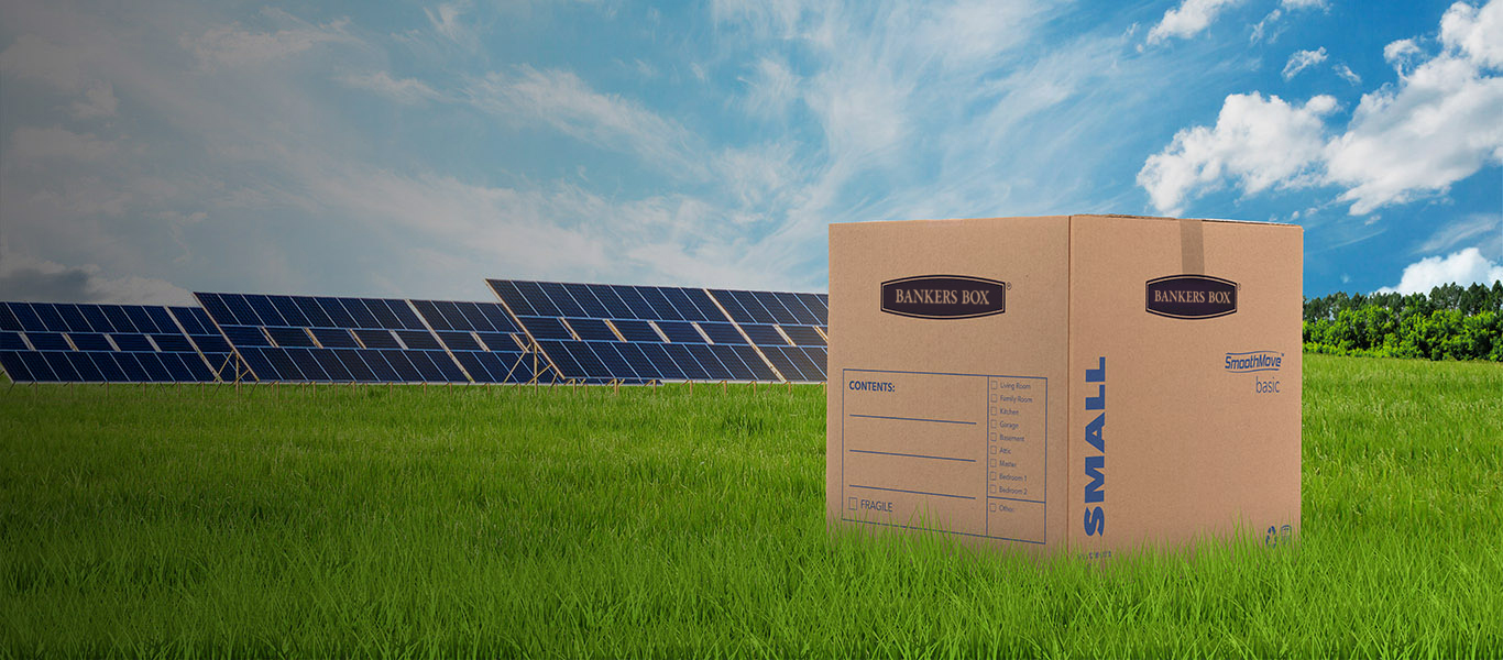 image of a moving box on the ground with green grass and trees around it