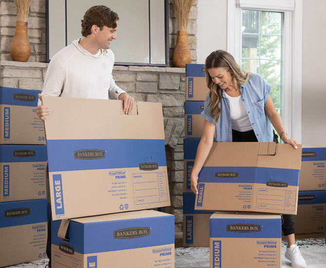 Woman carrying an unassembled box