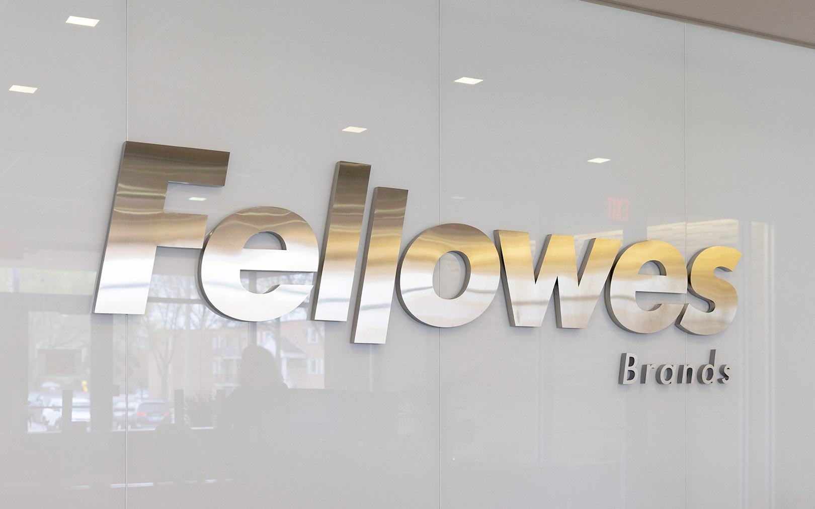 sitting man talking with standing woman in her office