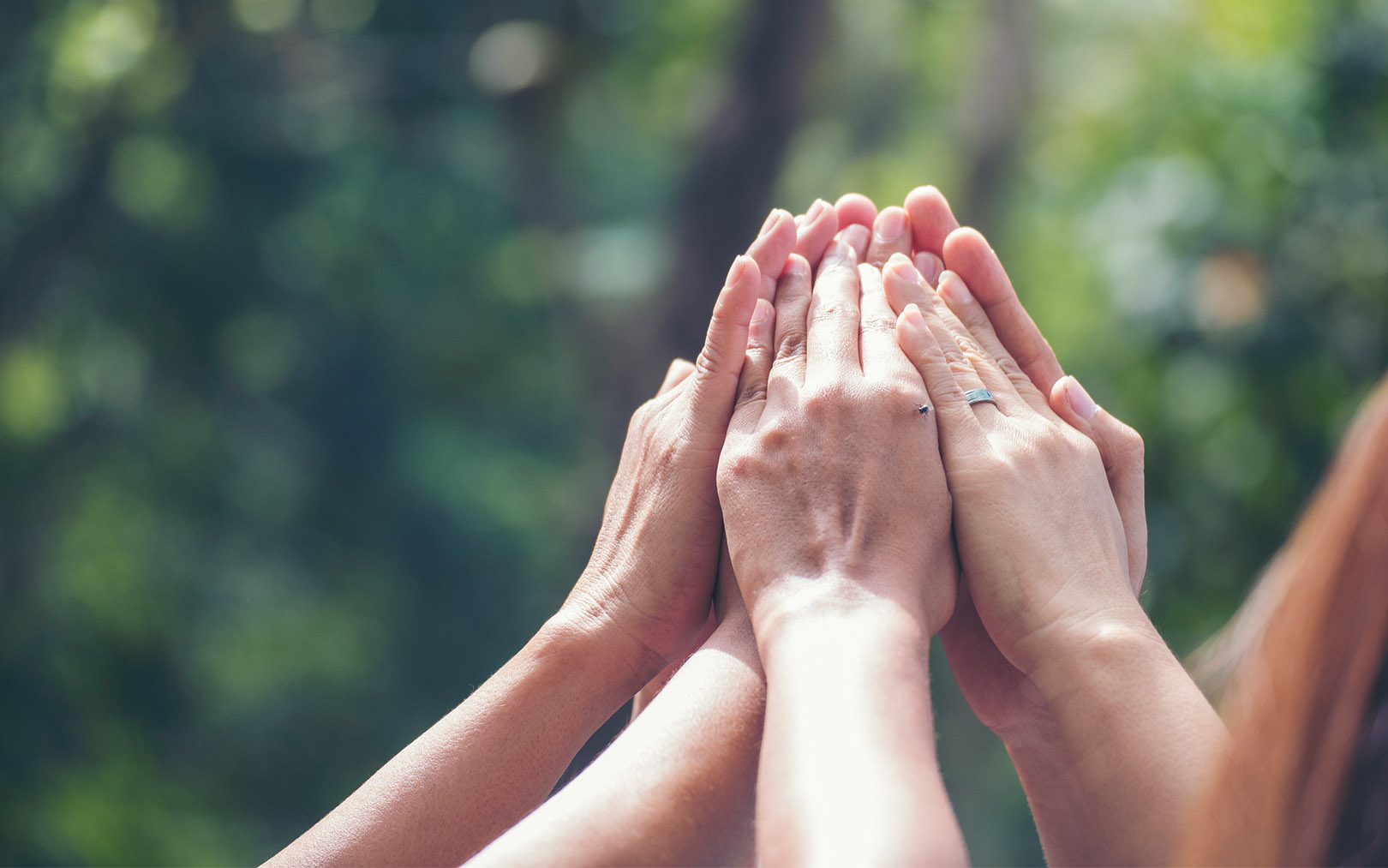 Image of volunteers helping patients with the word Give on top