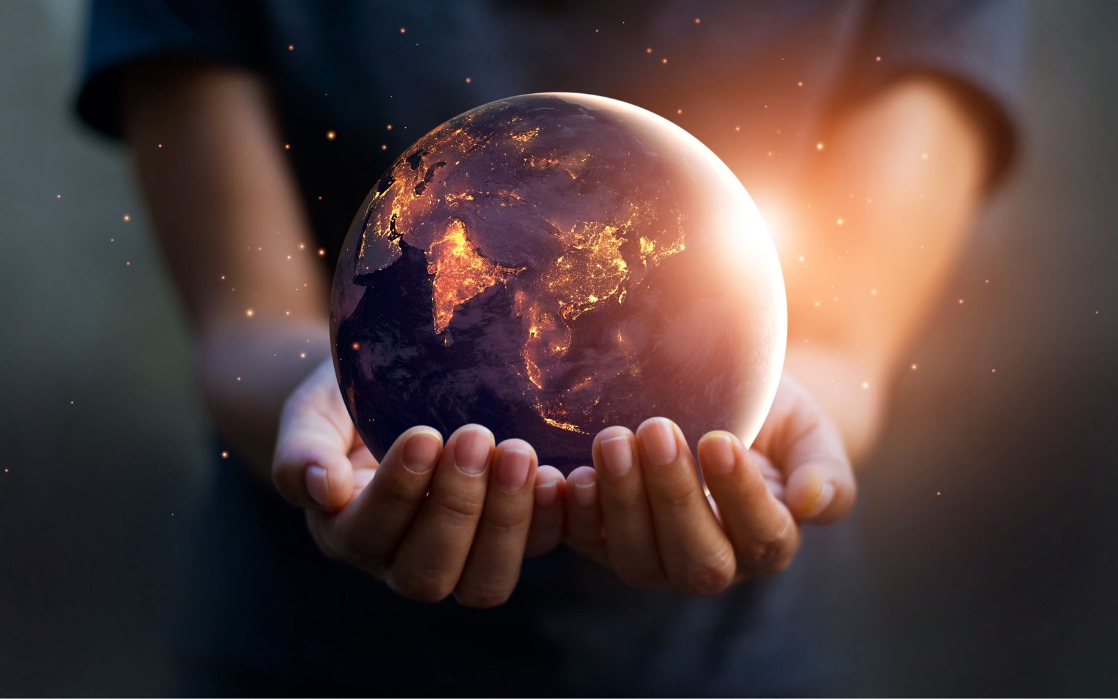 Out-stretched hands holding a globe of the Earth