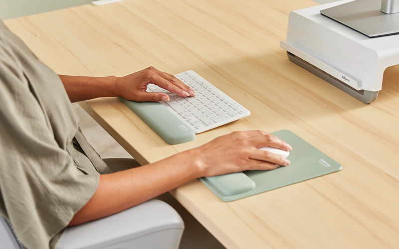 Woman using a mouse and wrist rest