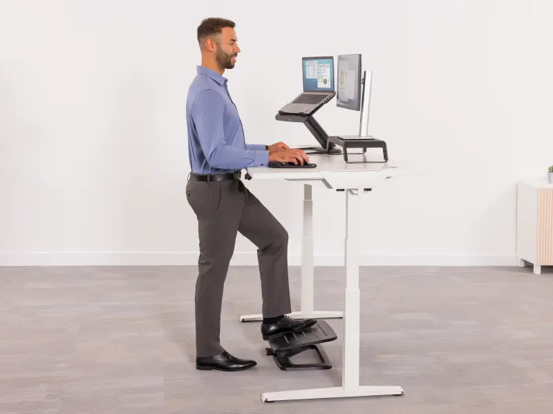 Man stood at a desk ergonomically