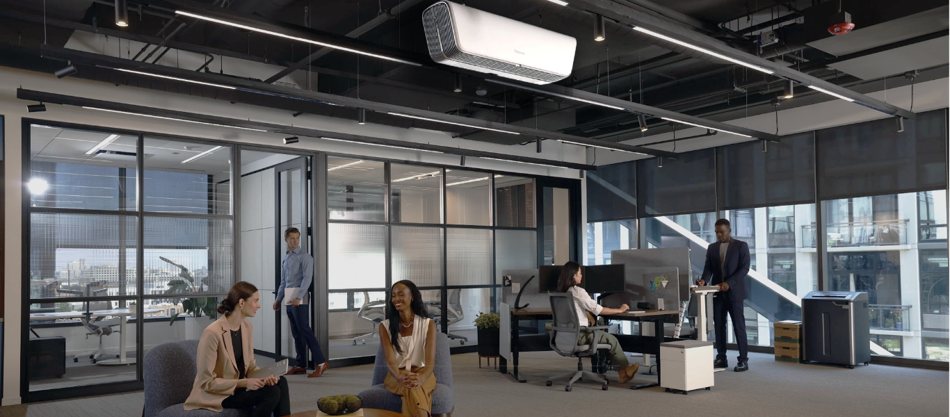 Photo of the inside of an office common space with people conversing
