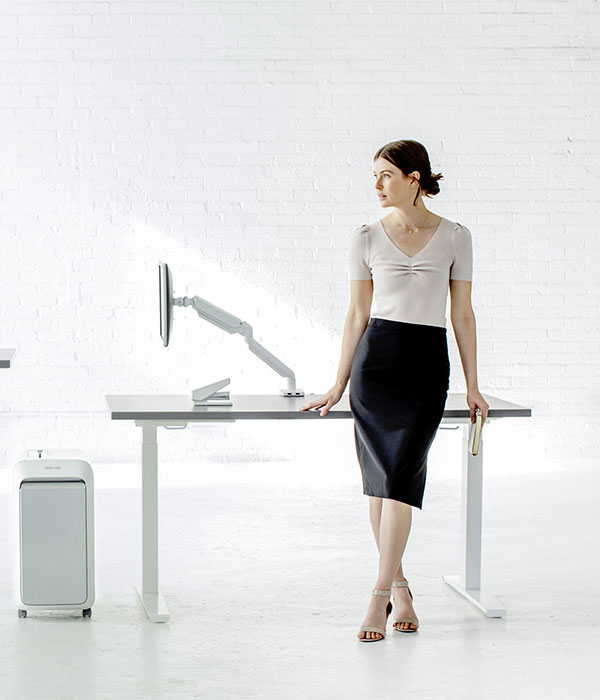 Business Woman Resting againts a Desk