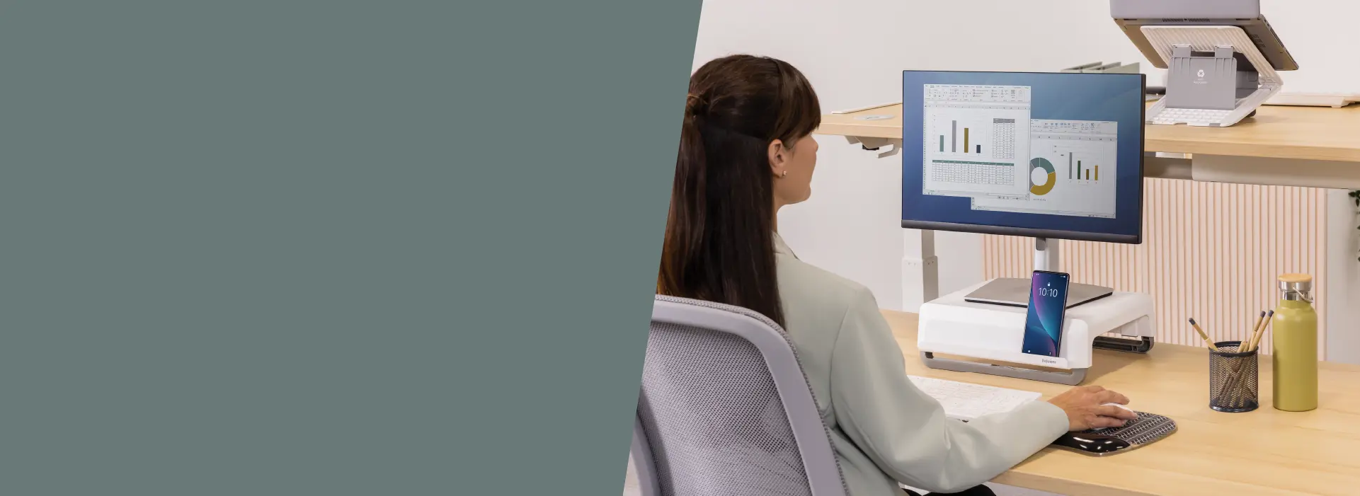 Woman using a monitor riser at a desk