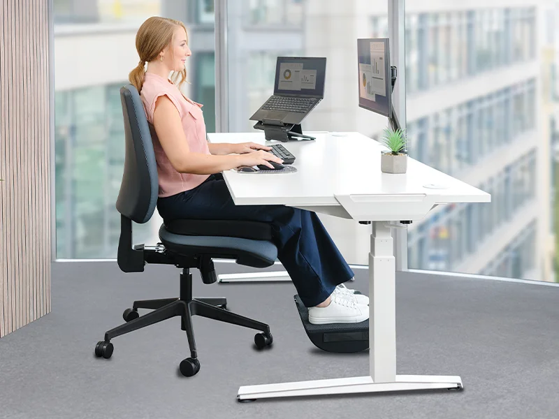 Woman sat at a desk ergonomically