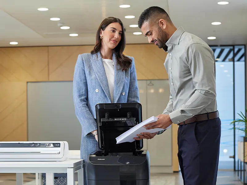 man and woman using a shredder