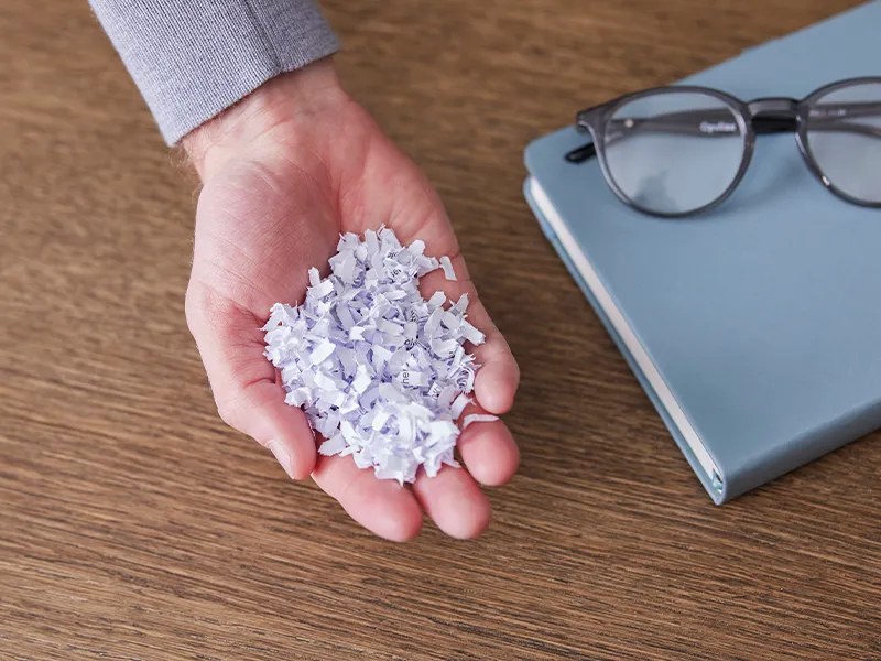 a handful of paper shredding particles