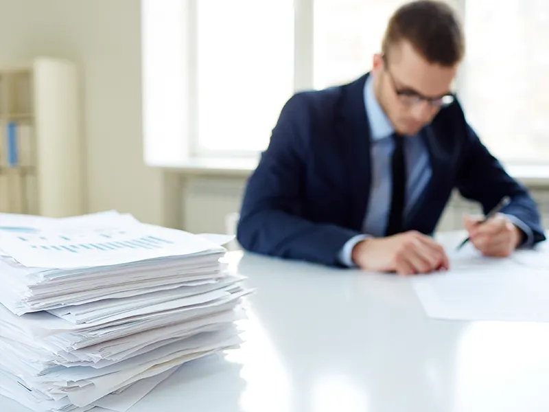 man sat in chair looking at data