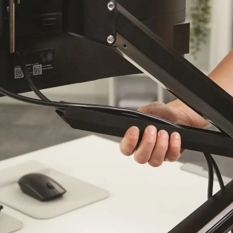 woman adjusting a monitor arm