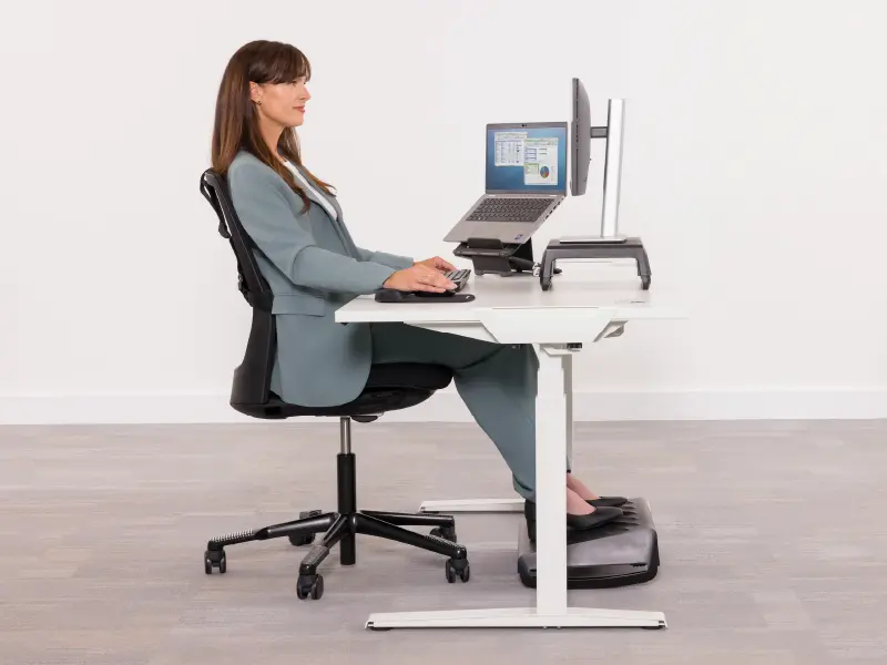Woman sat at a desk ergonomically
