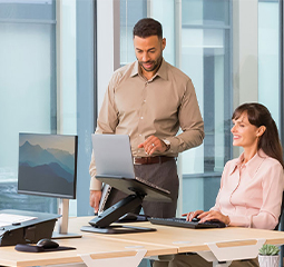 Image of man giving a workstation assessment to a woman