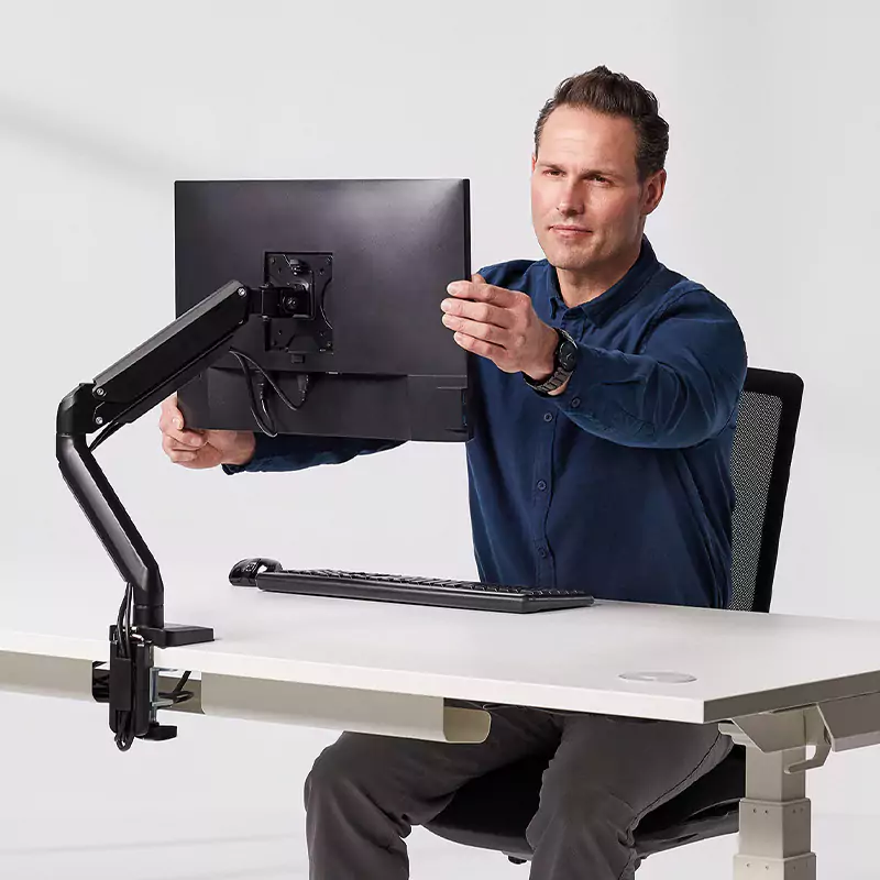 Man adjusting his monitor