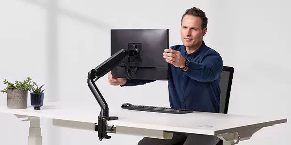 Man adjusting monitor arm