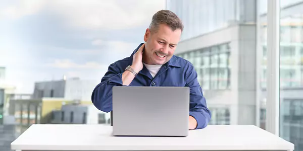 Man holding neck in pain