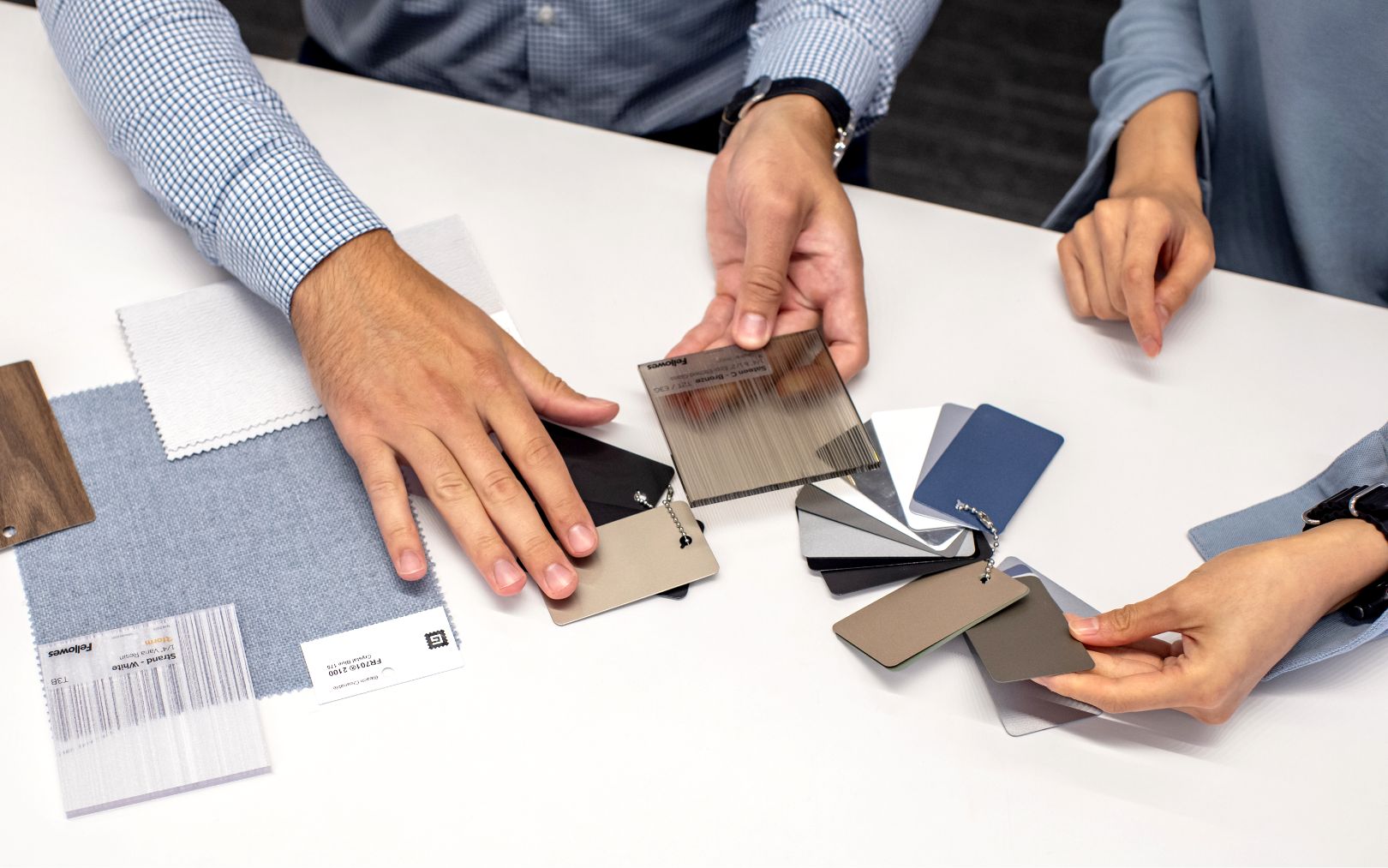 a top-down view of people's hands working at a table