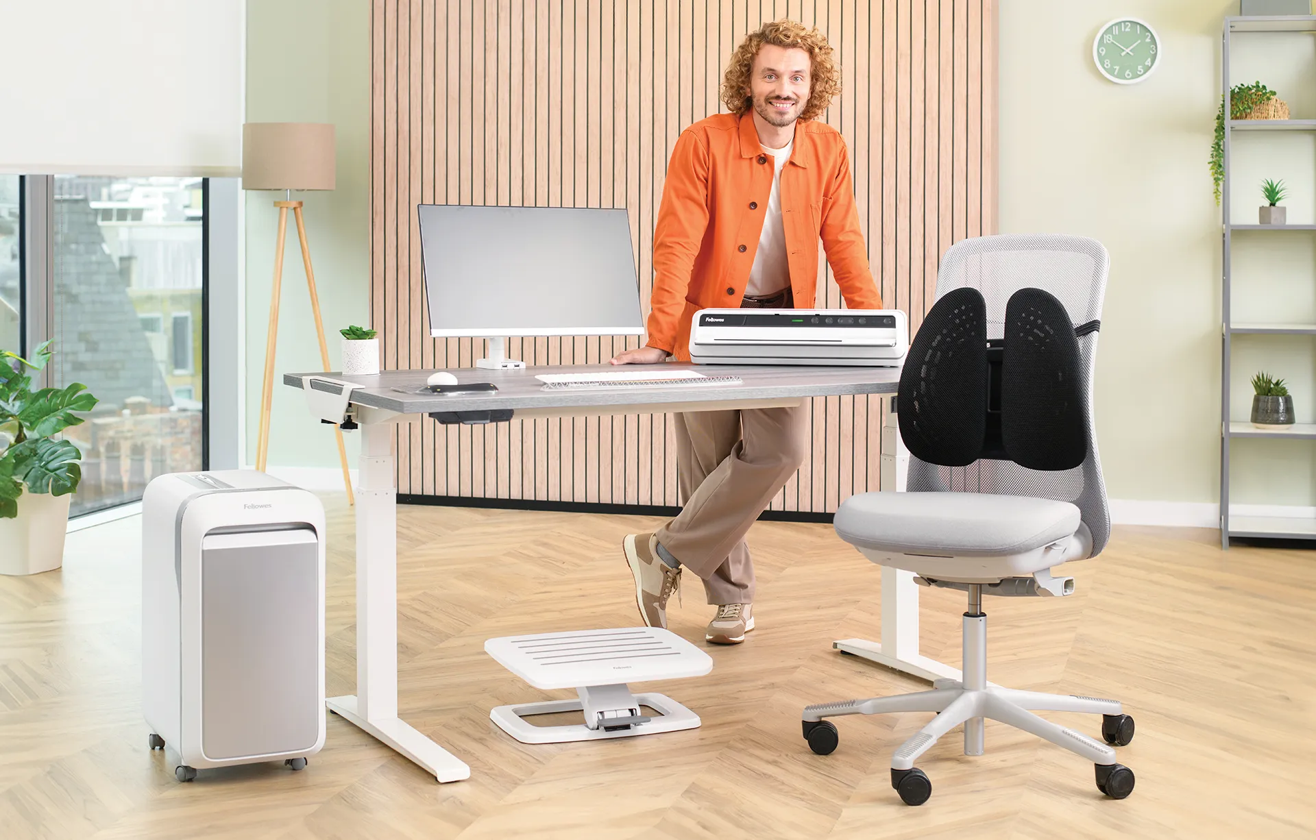 The WorkLife Coach leaning on a desk of Fellowes products
