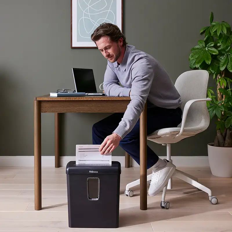 Man using a Fellowes shredder