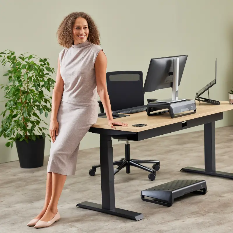 Lady stood by a desk