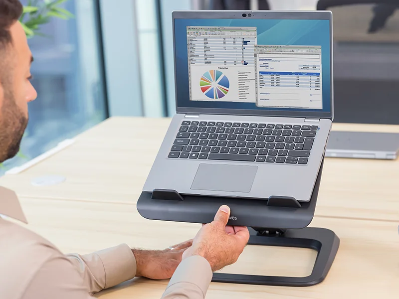 Man adjusting a laptop stand