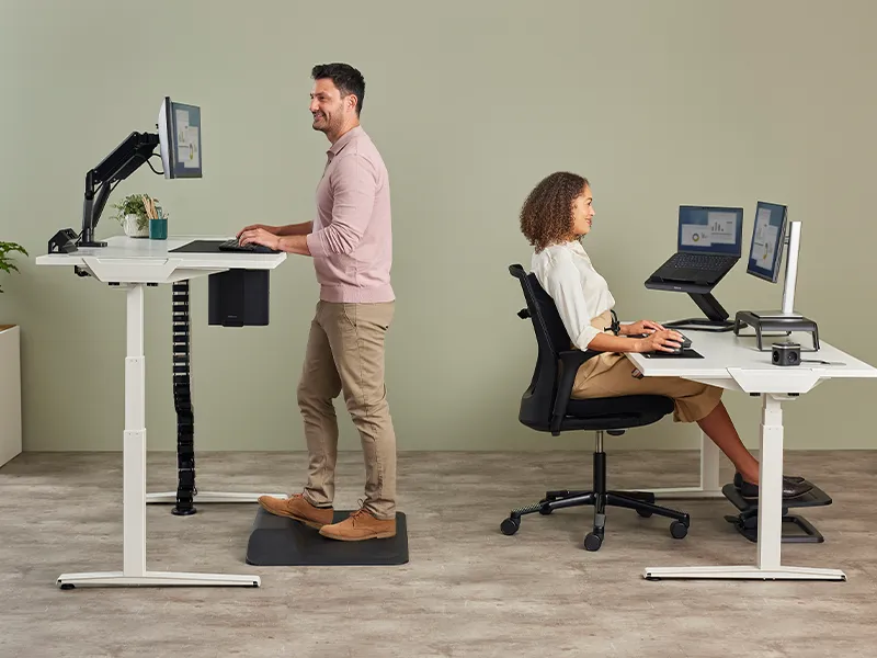 Work colleagues sat and stood ergonomically