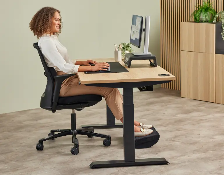 Lady sat working at a desk ergonomically