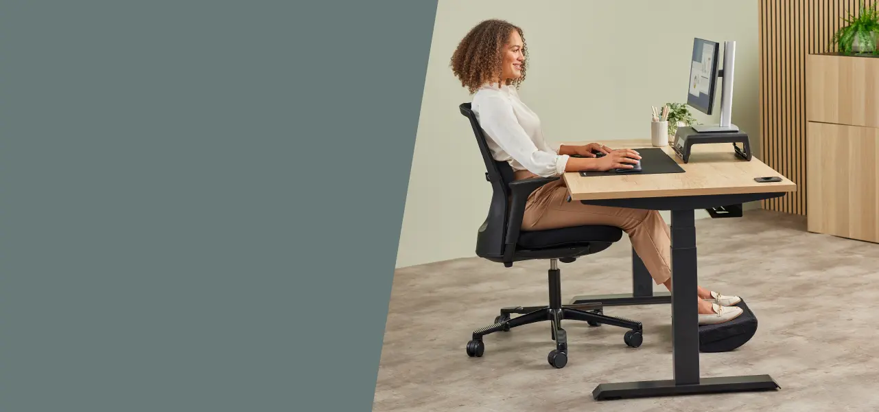 Lady sat working at a desk ergonomically