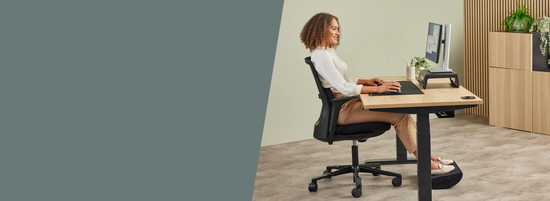 Lady sat working at a desk ergonomically