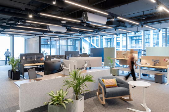 Image of a large open office space with someone walking across the room