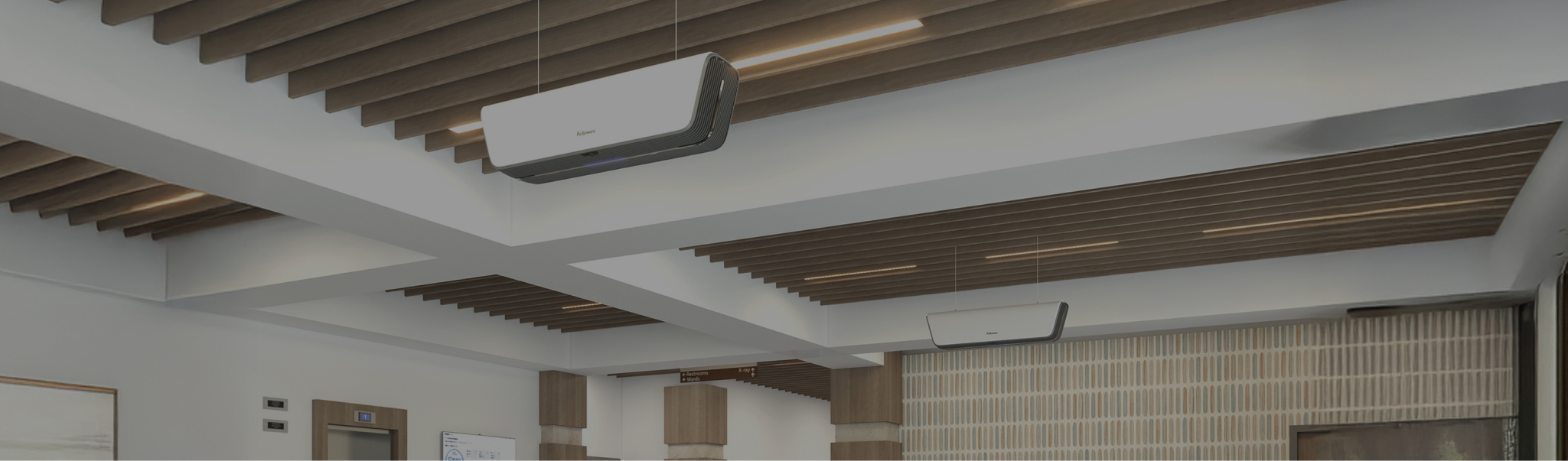 Image of a lobby area with two Array Ceiling units hanging from the beams.