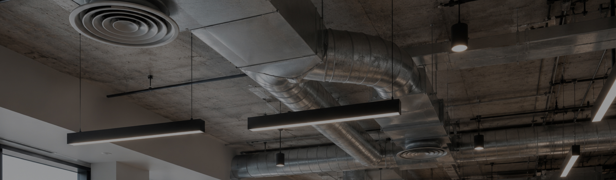 Image of exposed air conditioning ventilation in the ceiling of a building