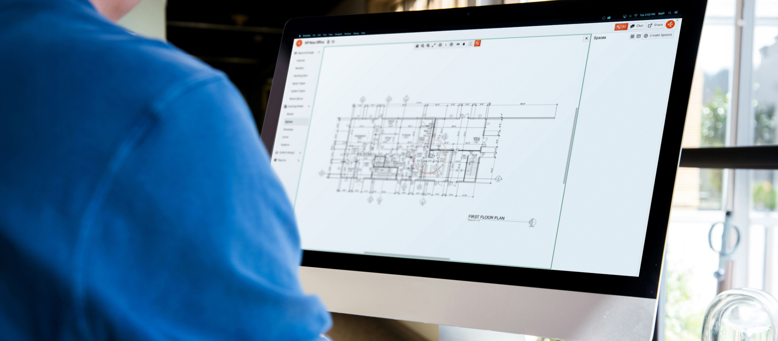 photo looking over someone's shoulder at a monitor with the HVAKR design software in view