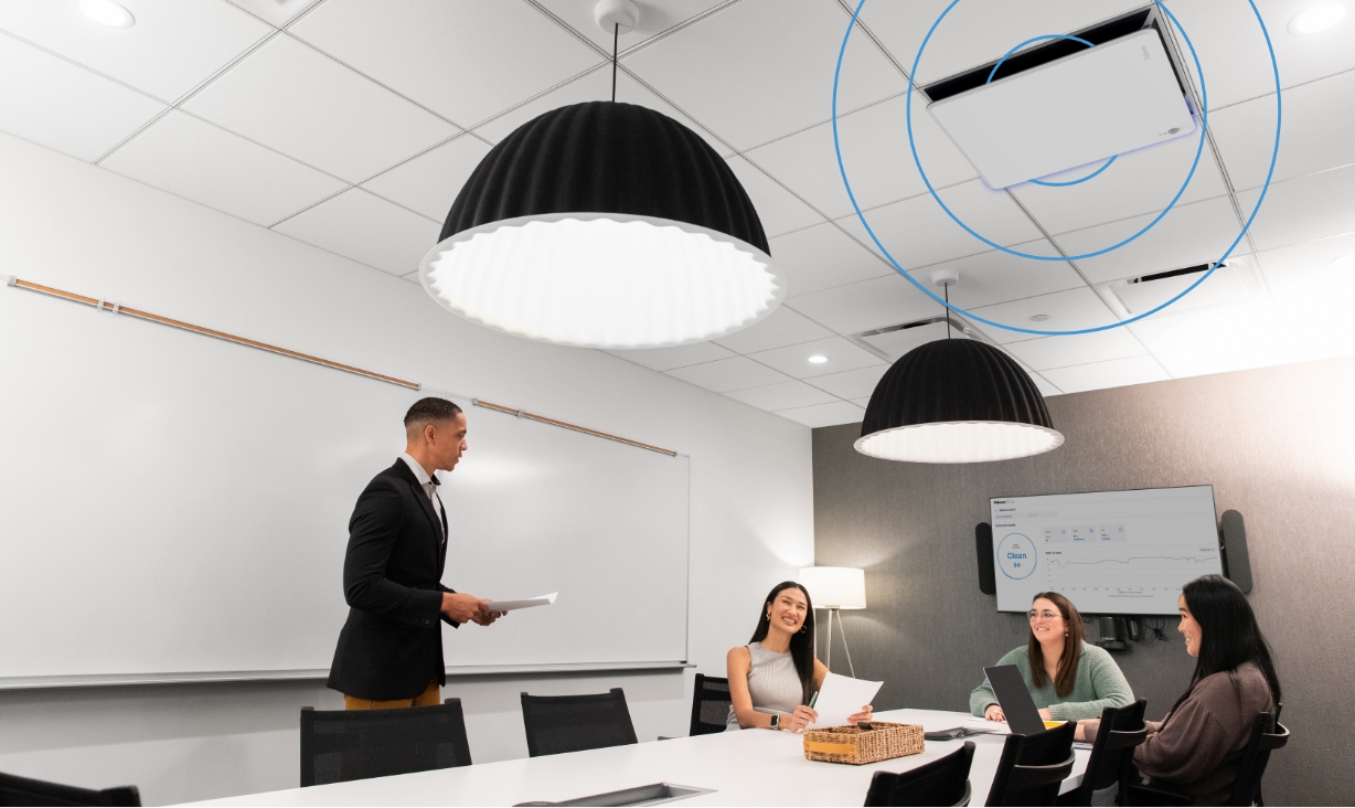 Image of people around a conference table discussing something