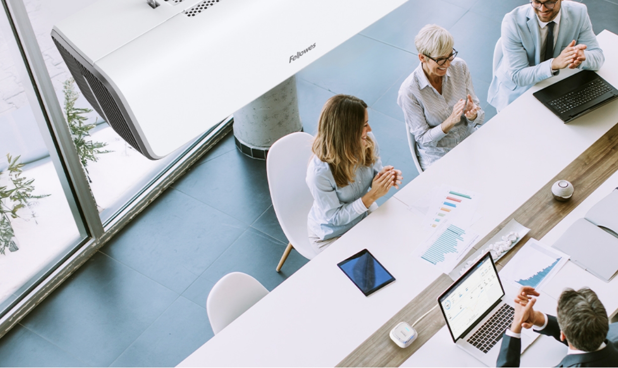 Image of people around a conference table taken from the view of the second floor