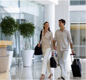 Man and woman walking into a hotel lobby