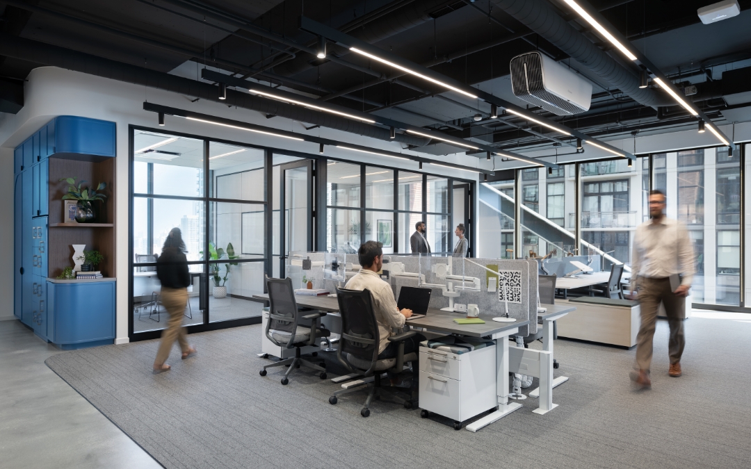 Image of multiple people walking and working in an office space