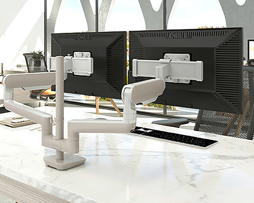 Image of a dual-arm monitor arm on a desk