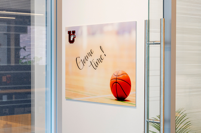 Image of a Markerboard with a custom background hanging on a wall in an office