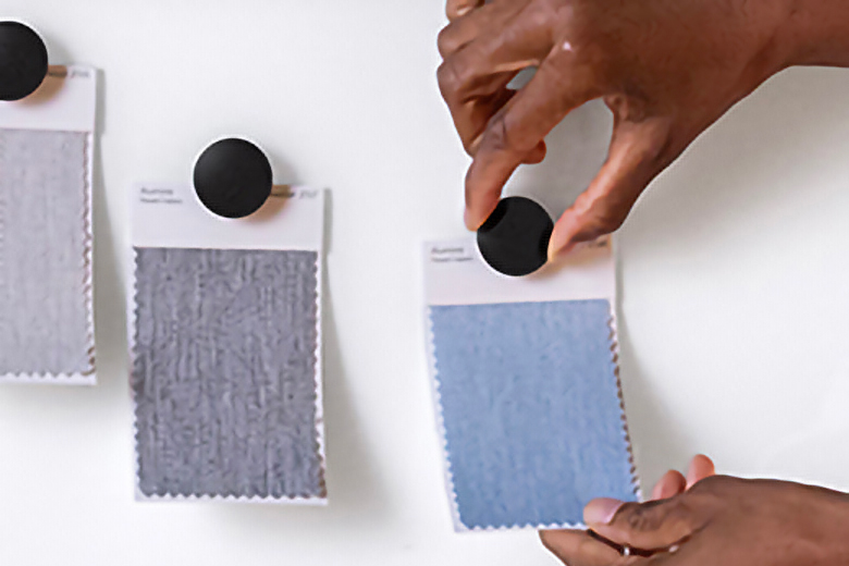 Image of magnets holding fabric samples to a Fellowes Markerboard