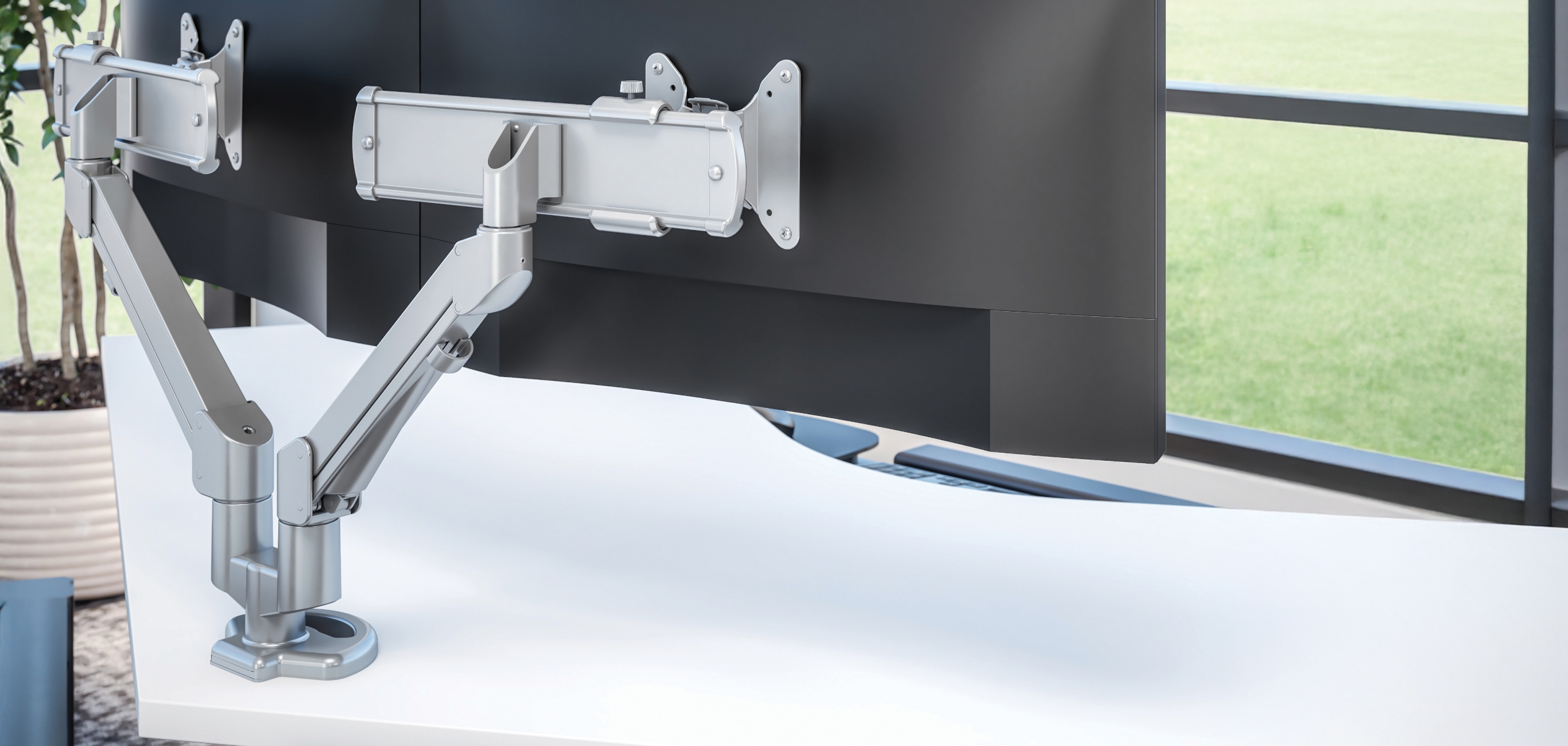 Image of a dual monitor arm attached to a desk