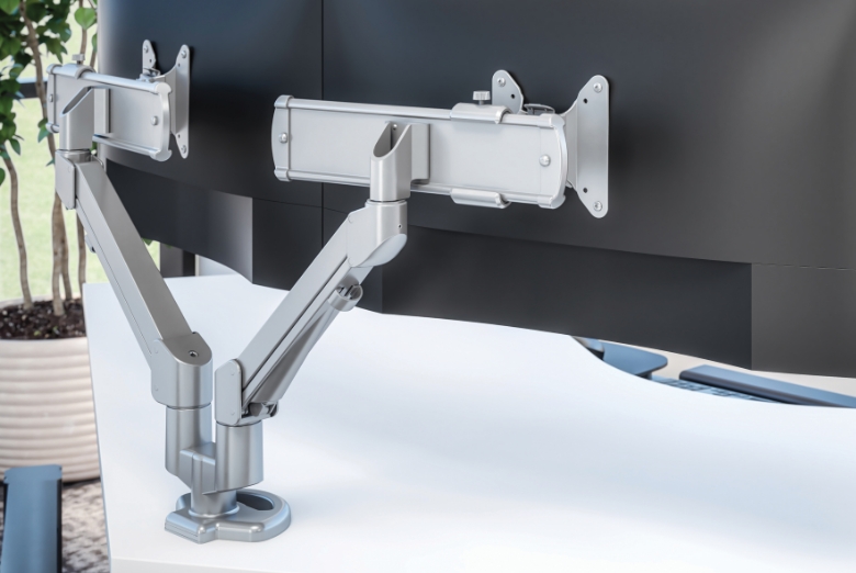 Image of a dual monitor arm attached to a desk