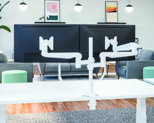 Image of a dual-arm monitor arm on a desk