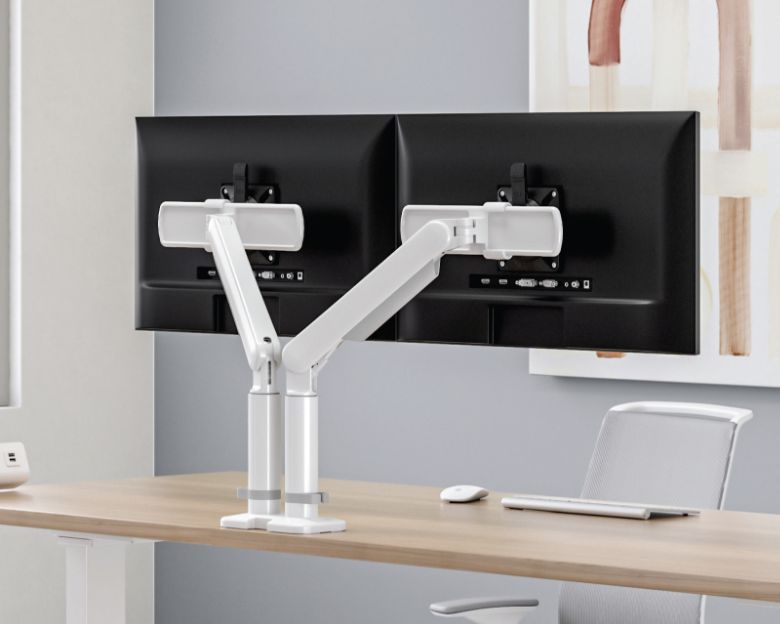 Image of a dual-arm monitor arm on a desk