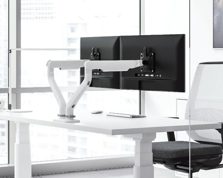 Image of a dual-arm monitor arm on a desk