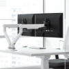 image of a monitor arm mounted on a desk